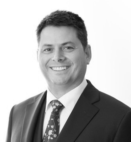 Professional man in a suit smiling for a portrait.