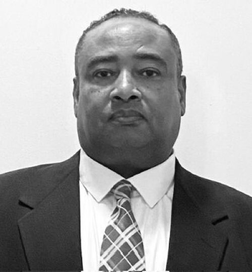 Portrait of a man in a suit and tie with a serious expression.